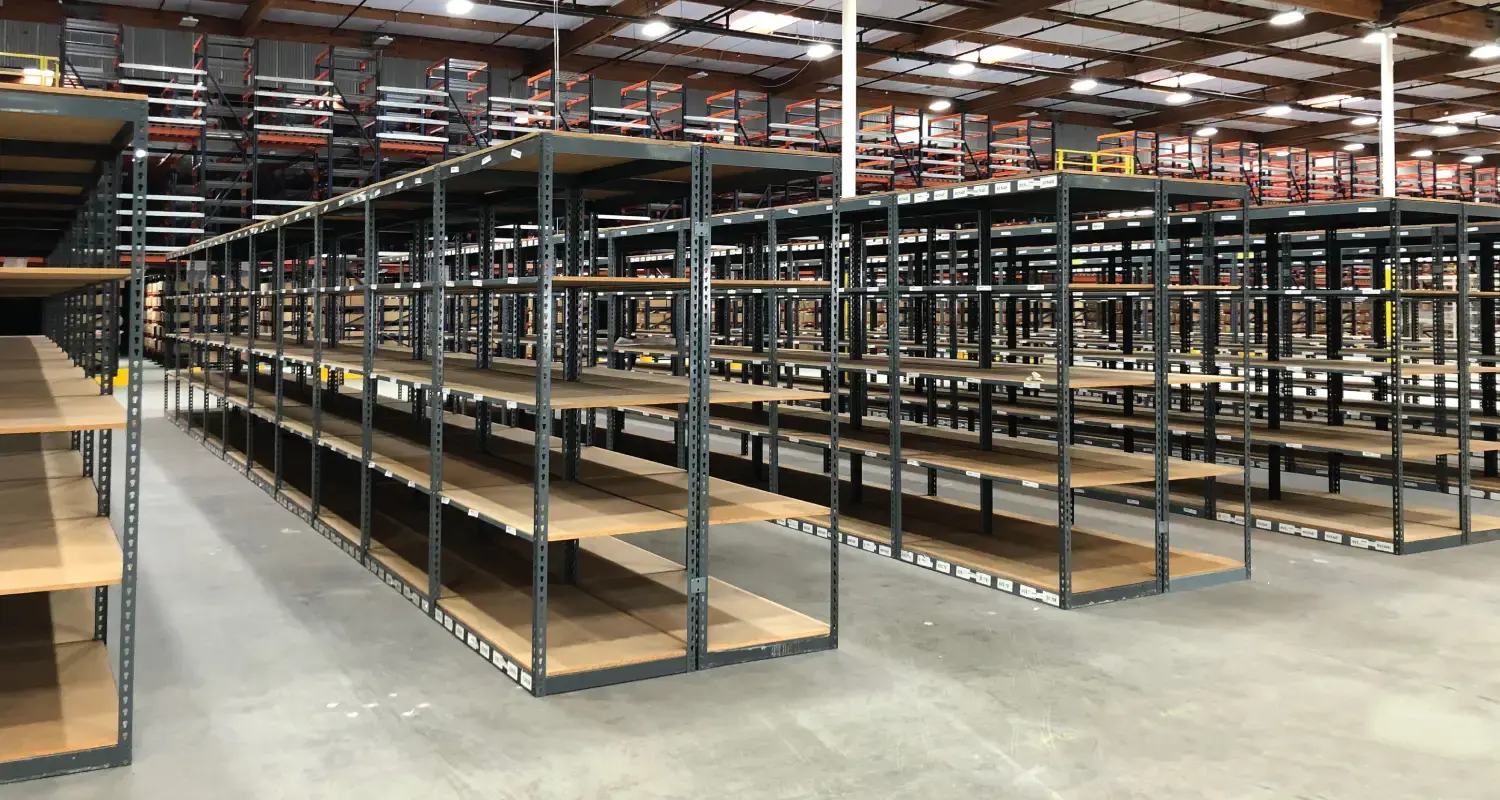 Empty boltless shelving inside of a warehouse